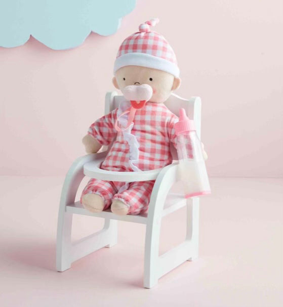 Baby doll with milk bottle and wooden chair