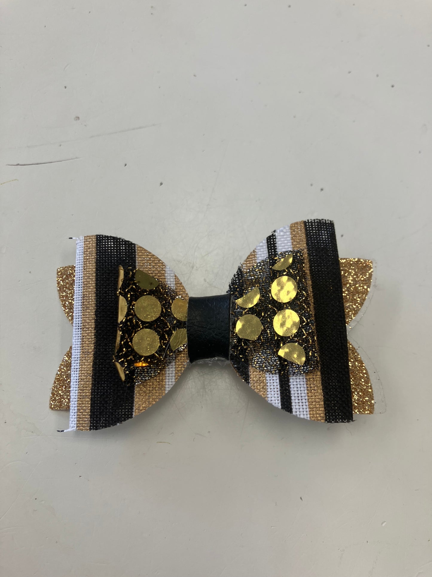 small black and gold metallic stripe sequin bow