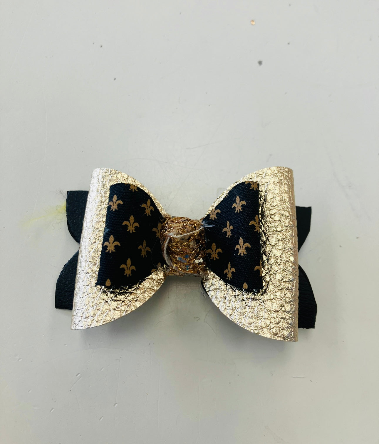 small black and gold fleur de lis metallic leather bow